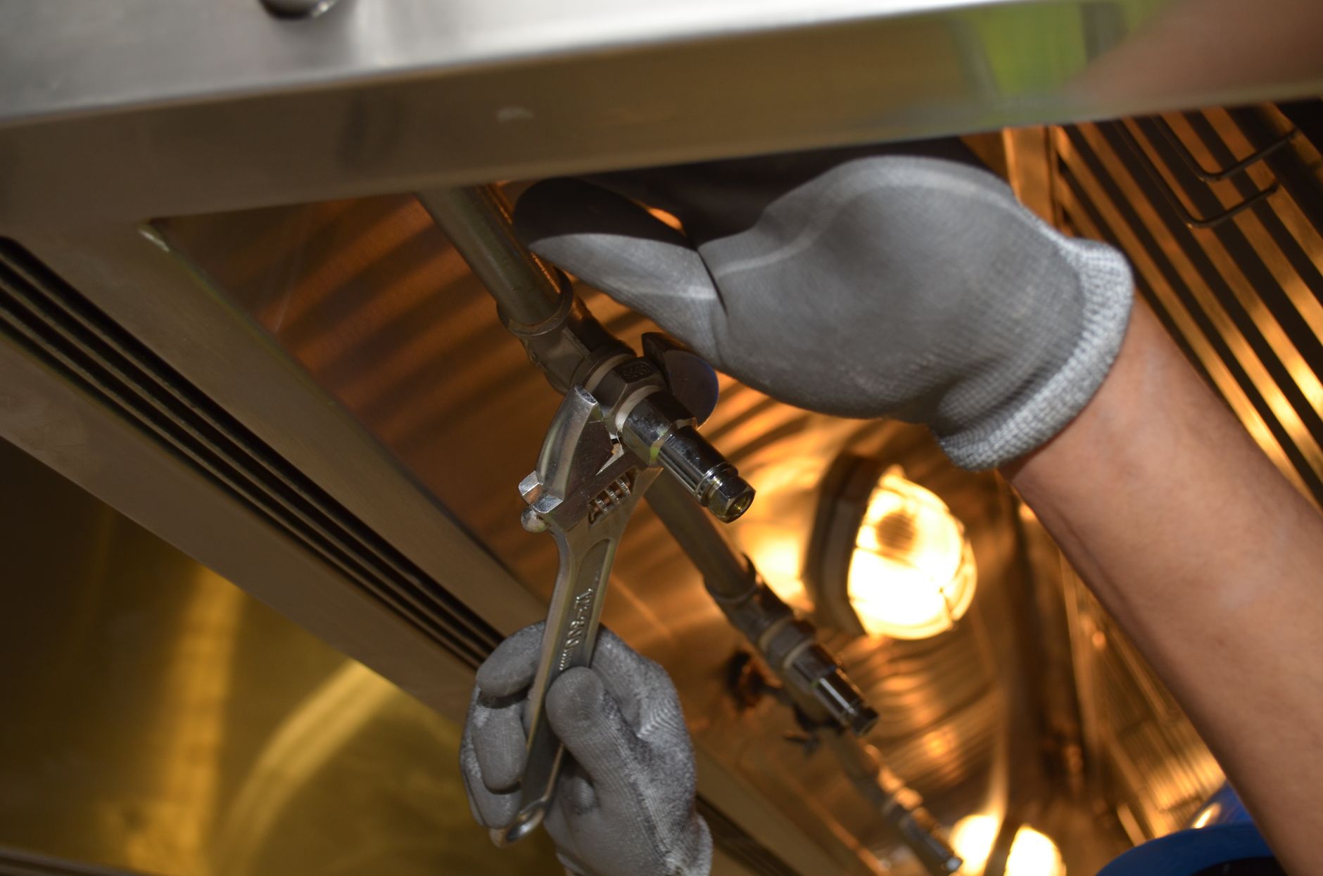 Plumber fixing pipes with hand tools