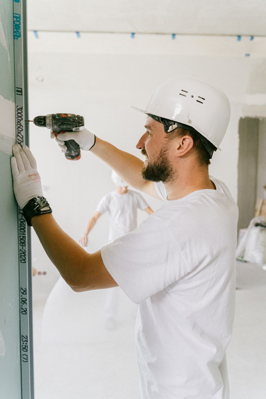 Contractor using a drill on a remodel